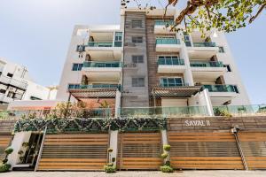 a tall apartment building with a garage in front of it at Cozy Apartment near Downtown Center in Santo Domingo