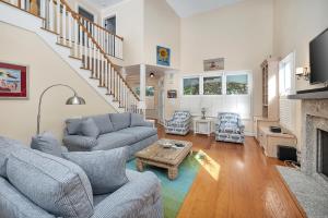 a living room with two couches and a fireplace at 12 Live Oak Place in Demere Park