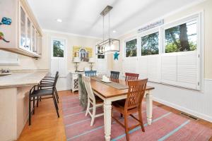a kitchen and dining room with a table and chairs at 12 Live Oak Place in Demere Park