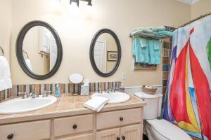a bathroom with two sinks and two mirrors at 12 Live Oak Place in Demere Park +20 photos