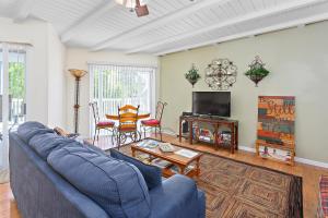 a living room with a blue couch and a table at 212 Olive Way in East End