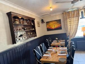 a dining room with a long table and chairs at 4 Sisters Inn in North Kyme