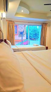 Ένα ή περισσότερα κρεβάτια σε δωμάτιο στο Home 24 Pattaya