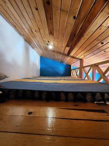 a bed in a room with a wooden ceiling at Hotel Ecológico Temazcal in Creel +20 photos