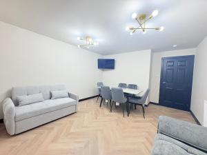 a living room with a couch and a table at F1 2BR Free Parking Walk Dist CityC in Glasgow