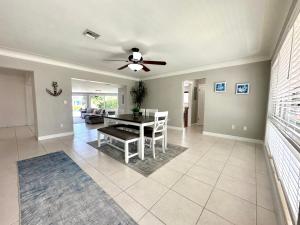 a dining room with a table and a ceiling fan at Waterfront Oasis in Pompano Beach