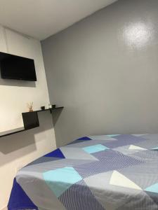 a bedroom with a bed and a flat screen tv at Hotel las nubes Barranquilla in Barranquilla