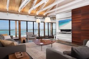 a living room with a tv and a couch and a table at Spectacular spacious 8 bedroom family villa in Providenciales +89 photos