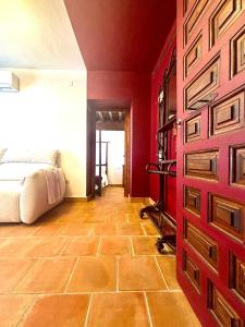 a bedroom with a bed and a red wall at Casa Basilia in Granada