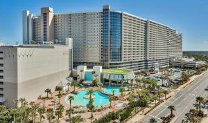 a large hotel with a swimming pool in front of a building at Laketown Wharf 331 in Panama City Beach