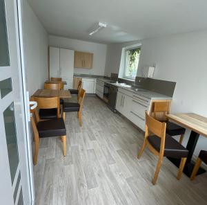 a kitchen and dining room with a table and chairs at Herr Berge in Fritzlar +13 photos