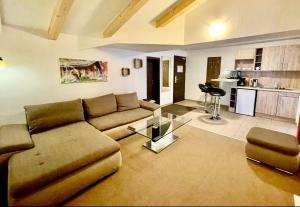 a living room with a couch and a glass table at Hotel Alta Vista in Neukirchen am Großvenediger