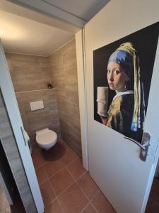 a painting of a woman on a bathroom door at Hostelion in Magdeburg +33 photos