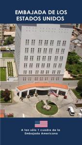 a large white building with the words embassy be los astros unions at American - Casa Hotel in La Paz