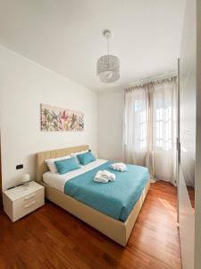 a bedroom with a large bed with blue sheets at Villoresi 6 - Moderno appartamento con giardino vicino Milano, Rho Fiera, Monza in Paderno Dugnano