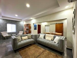 a living room with a couch and a table at Casa Papilon Family Home in Santa Cruz