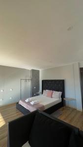 a bedroom with a bed and a couch at Porto Vista Douro Apart in Valbom