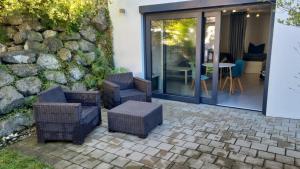 a patio with wicker chairs and a table at HO home in Ochsenhausen
