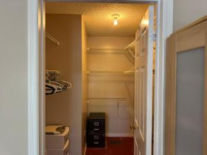a walk in pantry with a door open to a closet at Stylish Mississauga Escape Near Downtown in Mississauga