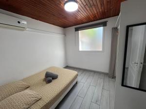 a small room with a bed and a window at Le Cataleya - Résidence Terre et Truffes in Le Lamentin +33 photos