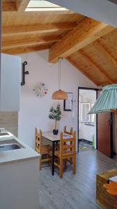 a kitchen and dining room with a table and chairs at Casa Vacanza L'Ulivo in Albenga +19 photos
