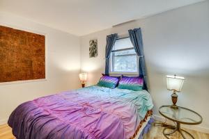 a bedroom with a bed with purple sheets and a window at 7 Mi to Bighorn Natl Forest Dog-Friendly Home in Ranchester