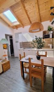 a kitchen with a wooden table and a dining room at Casa Vacanza L'Ulivo in Albenga