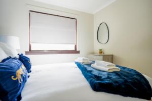 a bedroom with a bed with towels on it at Cliffburn House in Arbroath