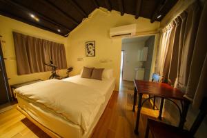 En eller flere senge i et værelse på 內之島旅宿 House