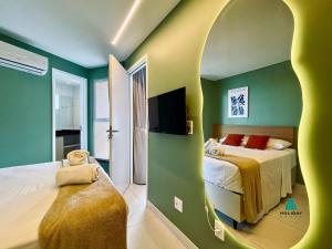 a bedroom with two beds and an arched doorway at Aquarius Style by Holiday Stays in Fortaleza