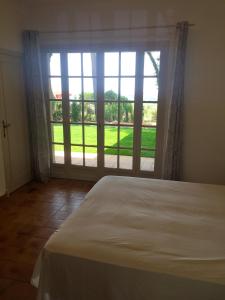 a bedroom with a bed and a large window at Villa Defendum in Vallauris