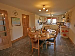 a kitchen and dining room with a table and chairs at Laggansally Lodge in Leswalt