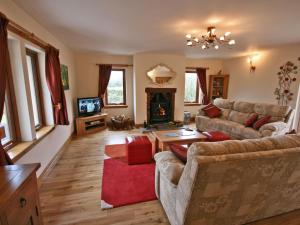 a living room with two couches and a fireplace at Laggansally Lodge in Leswalt
