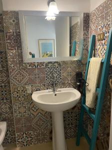 a bathroom with a sink and a mirror at Casa del Sorriso in Isola delle Femmine