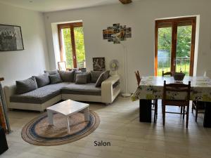 a living room with a couch and a table at La maison de Maxou in Briare