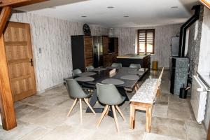 a dining room with a black table and chairs at Charmant Gîte avec sauna au cœur des Hautes Vosges in Ban-sur-Meurthe-Clefcy