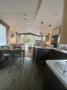 a kitchen and living room with a table and a dining room at Trecco Bay - Holiday Accommodation 18089 in Newton