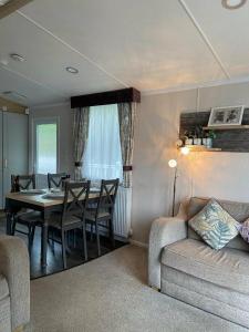 a living room with a table and chairs and a couch at Trecco Bay - Holiday Accommodation 18089 in Newton +8 photos