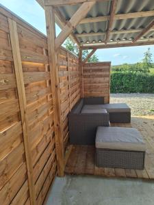 Aulnoye-Aymeriesにあるbienvenu au SPA ELENAのパティオに2つのベッドがある木製のパーゴラ