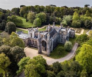 an aerial view of an old mansion with trees at Coastal Calm at Stanpit Hideaway in Christchurch