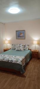 a bedroom with a bed with two lamps and a bed sidx sidx sidx at Wild lakes home in Burgas City
