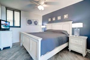 a bedroom with a bed and a ceiling fan at Beautiful Oceanfront Condo in Panama City Beach +14 photos
