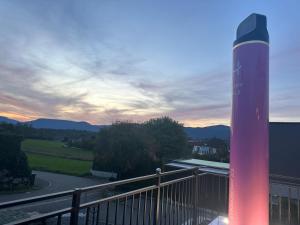 a building with a red pole on a balcony at Beautiful, luxurious Caravane property in Rothrist