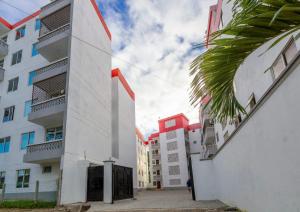 an empty street in a city with buildings at Terry's Haven with AC in Mombasa