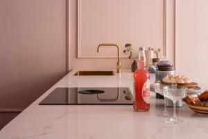 a kitchen with a counter with a sink and a plate of food at Luxurious boutique apartment near city centre in Groningen