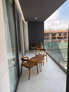 a balcony with two chairs and a table on a building at Real Homes 2 bedroom Nova Apartments in Accra