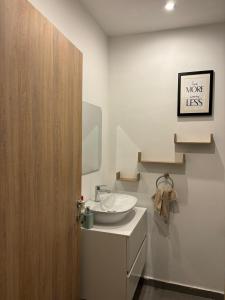 a bathroom with a sink and a mirror at Real Homes 2 bedroom Nova Apartments in Accra