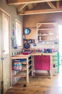a kitchen with a wooden counter and a red cabinet at Casa de la Luna in Nuevo León