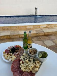a table topped with different types of food and bottles of beer at Casa Beach park in Aquiraz