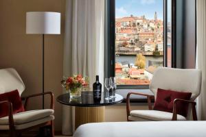 a hotel room with a table and two chairs and a window at Tivoli Kopke Porto Gaia Hotel in Vila Nova de Gaia